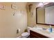 This charming powder room features a decorative mirror, pedestal sink, and neutral decor at 4260 Helena Cove Ct, Las Vegas, NV 89129