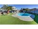 A backyard pool with synthetic grass, palm trees, and covered gazebo at 4474 Dawley Ct, Las Vegas, NV 89104