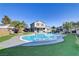 Backyard featuring an in-ground pool, manicured landscaping, and a covered patio area at 4474 Dawley Ct, Las Vegas, NV 89104