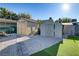 Backyard featuring a variety of storage sheds over a rock ground cover with artificial turf at 4474 Dawley Ct, Las Vegas, NV 89104