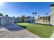 Spacious backyard featuring well manicured turf, multiple sheds, gazebo, and desert landscaping at 4474 Dawley Ct, Las Vegas, NV 89104