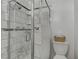 Tiled bathroom with glass enclosed shower and toilet at 4474 Dawley Ct, Las Vegas, NV 89104