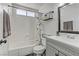 Clean bathroom features a shower-tub combo, vanity, and modern mirror at 4474 Dawley Ct, Las Vegas, NV 89104