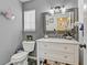 A charming half-bathroom features a vanity with marble countertop and modern fixtures with decor at 4474 Dawley Ct, Las Vegas, NV 89104