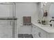Elegant bathroom featuring double sinks, marble floors, and glass enclosed shower at 4474 Dawley Ct, Las Vegas, NV 89104