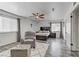 Bright bedroom boasts wood-look floors, ceiling fan, and a comfortable sitting area with plush rug at 4474 Dawley Ct, Las Vegas, NV 89104