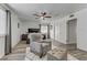 Bright primary bedroom with wood floors, a ceiling fan, and a plush chair at 4474 Dawley Ct, Las Vegas, NV 89104