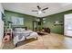 Spacious bedroom with a ceiling fan, tile floors, and stylish decor offers a comfortable retreat at 4474 Dawley Ct, Las Vegas, NV 89104