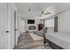 The bedroom boasts wood floors, a ceiling fan, closet, and a plush chair at 4474 Dawley Ct, Las Vegas, NV 89104