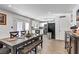 Open dining area featuring a dark wood table and bench seating adjacent to the well-appointed kitchen at 4474 Dawley Ct, Las Vegas, NV 89104