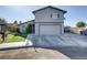 Two-story home featuring a two-car garage, desert landscaping, and a long driveway at 4474 Dawley Ct, Las Vegas, NV 89104