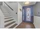 Bright foyer featuring decorative front door, wood-look floors, and staircase to the second level at 4474 Dawley Ct, Las Vegas, NV 89104