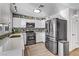 A modern kitchen showcases white cabinets, stainless steel appliances, and a decorative backsplash for a sleek design at 4474 Dawley Ct, Las Vegas, NV 89104