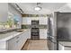 Modern kitchen featuring stainless steel appliances, white cabinetry, and a mosaic tile backsplash at 4474 Dawley Ct, Las Vegas, NV 89104