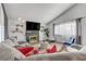 Living room featuring vaulted ceilings, fireplace, large sectional sofa and bright natural light at 4474 Dawley Ct, Las Vegas, NV 89104
