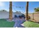 A backyard patio with a fire pit and palm trees at 4474 Dawley Ct, Las Vegas, NV 89104
