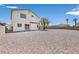 Backyard featuring a spacious gravel area, mature tree, and block wall at 4583 Sparwood Dr, Las Vegas, NV 89147
