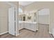 Main bath featuring dual sinks, modern lighting, and ensuite access at 4583 Sparwood Dr, Las Vegas, NV 89147