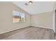 Bright bedroom featuring wood-look floors, a window with blinds, and ample natural light at 4583 Sparwood Dr, Las Vegas, NV 89147