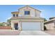 Two-story home featuring a two-car garage, blue door, tile roof, and neutral stucco facade at 4583 Sparwood Dr, Las Vegas, NV 89147