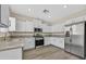Modern kitchen featuring stainless steel appliances, granite countertops, and white cabinets at 4583 Sparwood Dr, Las Vegas, NV 89147