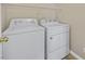 Laundry area featuring white washer and dryer with wire shelving above at 4583 Sparwood Dr, Las Vegas, NV 89147