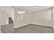Bright living room featuring neutral walls, wood-look floors, and staircase access at 4583 Sparwood Dr, Las Vegas, NV 89147