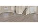 Spacious living room featuring wood-look floors and a staircase with white railings at 4583 Sparwood Dr, Las Vegas, NV 89147