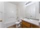 Clean bathroom featuring a single sink, toilet and tub with white tile at 4730 E Craig Rd # 1115, Las Vegas, NV 89115