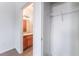 Bright room with white walk-in closet adjacent to bathroom featuring wooden sink and tile floor at 4730 E Craig Rd # 1115, Las Vegas, NV 89115