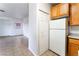 A well-lit kitchen area showing wooden cabinets and white appliances, next to the bedroom at 4730 E Craig Rd # 1115, Las Vegas, NV 89115