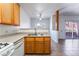 Kitchen features stainless steel sink with wood cabinetry and a view to the living area at 4730 E Craig Rd # 1115, Las Vegas, NV 89115