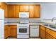 Well-equipped kitchen with white appliances and wooden cabinets at 4730 E Craig Rd # 1115, Las Vegas, NV 89115