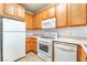 Well-equipped kitchen with white appliances, light countertops, and light wood cabinets at 4730 E Craig Rd # 1115, Las Vegas, NV 89115