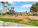 Community playground with colorful equipment and grassy areas for recreation at 4730 E Craig Rd # 1115, Las Vegas, NV 89115