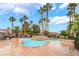 Community swimming pool surrounded by palm trees and well-maintained landscaping at 4730 E Craig Rd # 1115, Las Vegas, NV 89115