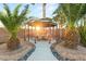 Inviting backyard space with a gazebo featuring a fire pit table, seating, and lush landscaping at 4764 Lana Dr, Las Vegas, NV 89121