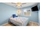 Comfortable bedroom with light blue walls, wood-look floors, and a window at 4764 Lana Dr, Las Vegas, NV 89121