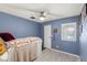 Cozy bedroom featuring light wood floors, a ceiling fan and a quaint decor and color palette at 4764 Lana Dr, Las Vegas, NV 89121