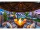 Inviting backyard gazebo featuring a fire pit and comfortable seating, ideal for outdoor entertaining at 4764 Lana Dr, Las Vegas, NV 89121
