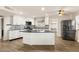 Modern kitchen with white cabinets, stainless steel appliances, mosaic backsplash, and black marble countertops at 4764 Lana Dr, Las Vegas, NV 89121