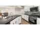 Open concept kitchen features marble countertops, white cabinets, mosaic backsplash, and stainless steel appliances at 4764 Lana Dr, Las Vegas, NV 89121