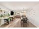 Bright, open-concept living room and dining area with large windows and stylish decor at 4764 Lana Dr, Las Vegas, NV 89121