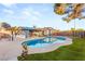 Backyard with a sparkling pool, patio area, and lush green lawn, perfect for outdoor enjoyment at 4764 Lana Dr, Las Vegas, NV 89121