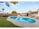 Backyard with a pool, hot tub, covered patio, and lush landscaping at 4764 Lana Dr, Las Vegas, NV 89121