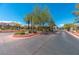 Gated entrance to Painted Desert community features desert landscaping and lush foliage at 4830 Grey Wolf Ln # 104, Las Vegas, NV 89149
