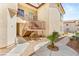 Tan stucco building featuring stairs to upper units, desert landscaping, and walkways at 4830 Grey Wolf Ln # 104, Las Vegas, NV 89149