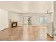 Spacious living room with tile flooring, fireplace, ceiling fan, and sliding glass doors to patio at 4830 Grey Wolf Ln # 104, Las Vegas, NV 89149