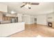 Open living room with a fireplace, tiled flooring, and access to the kitchen and laundry room at 4830 Grey Wolf Ln # 104, Las Vegas, NV 89149