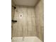 Bathroom with walk-in shower featuring newly tiled walls and updated fixtures at 4910 Elizabeth St, Pahrump, NV 89048